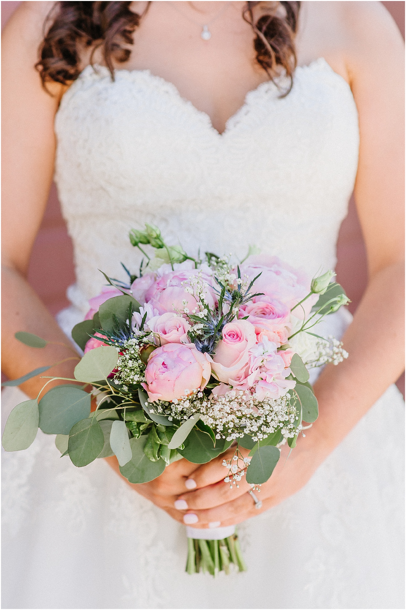 bride holding pink and green summer bouquet