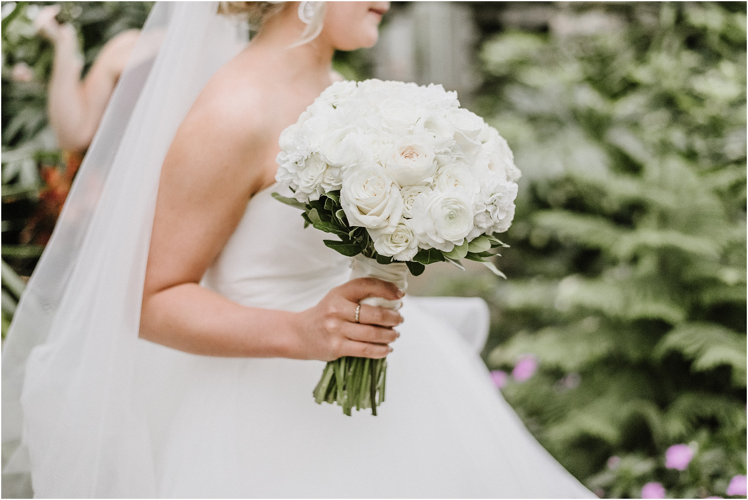 bride holding green and white bouquet