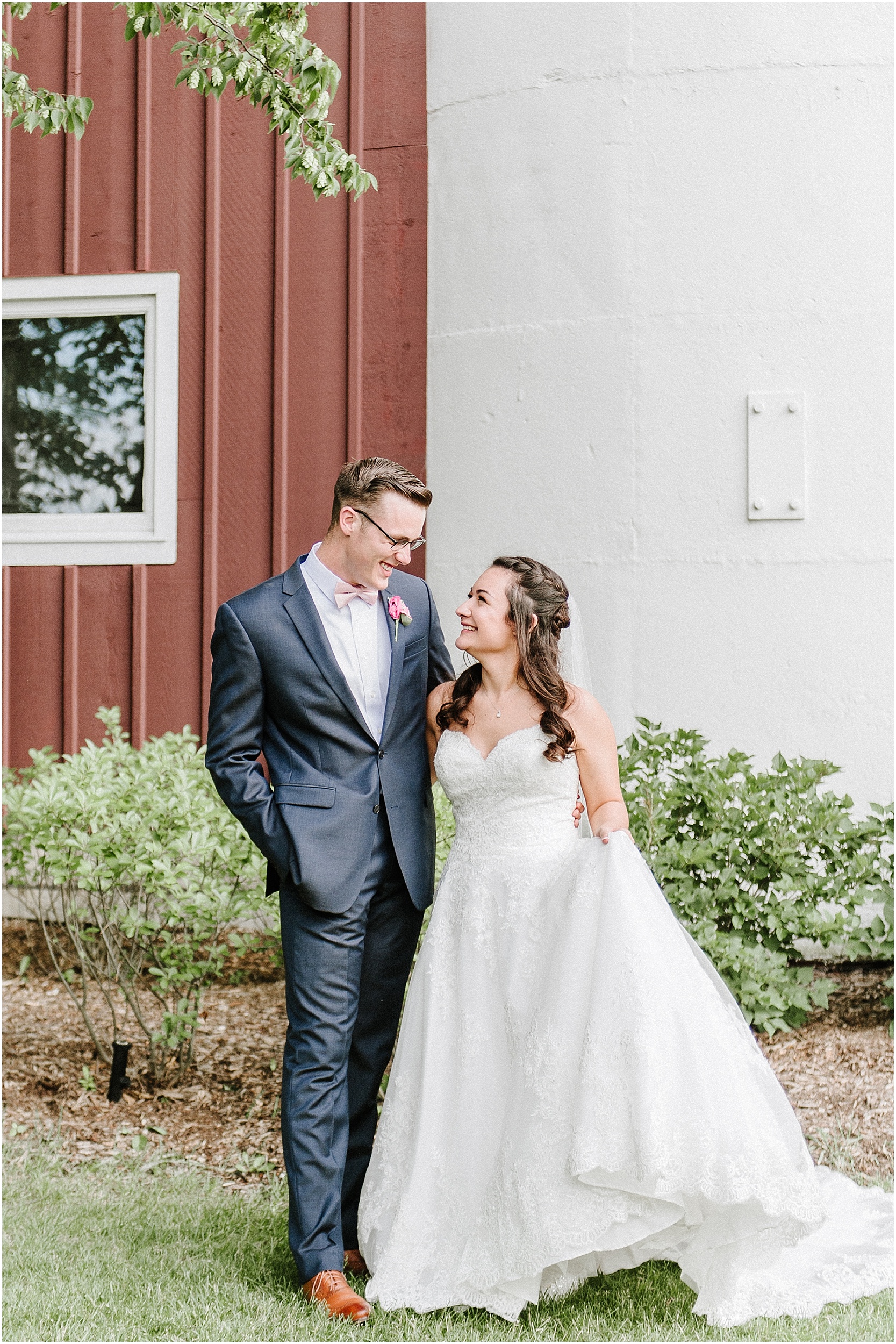 bride and groom in front of barn in illinois