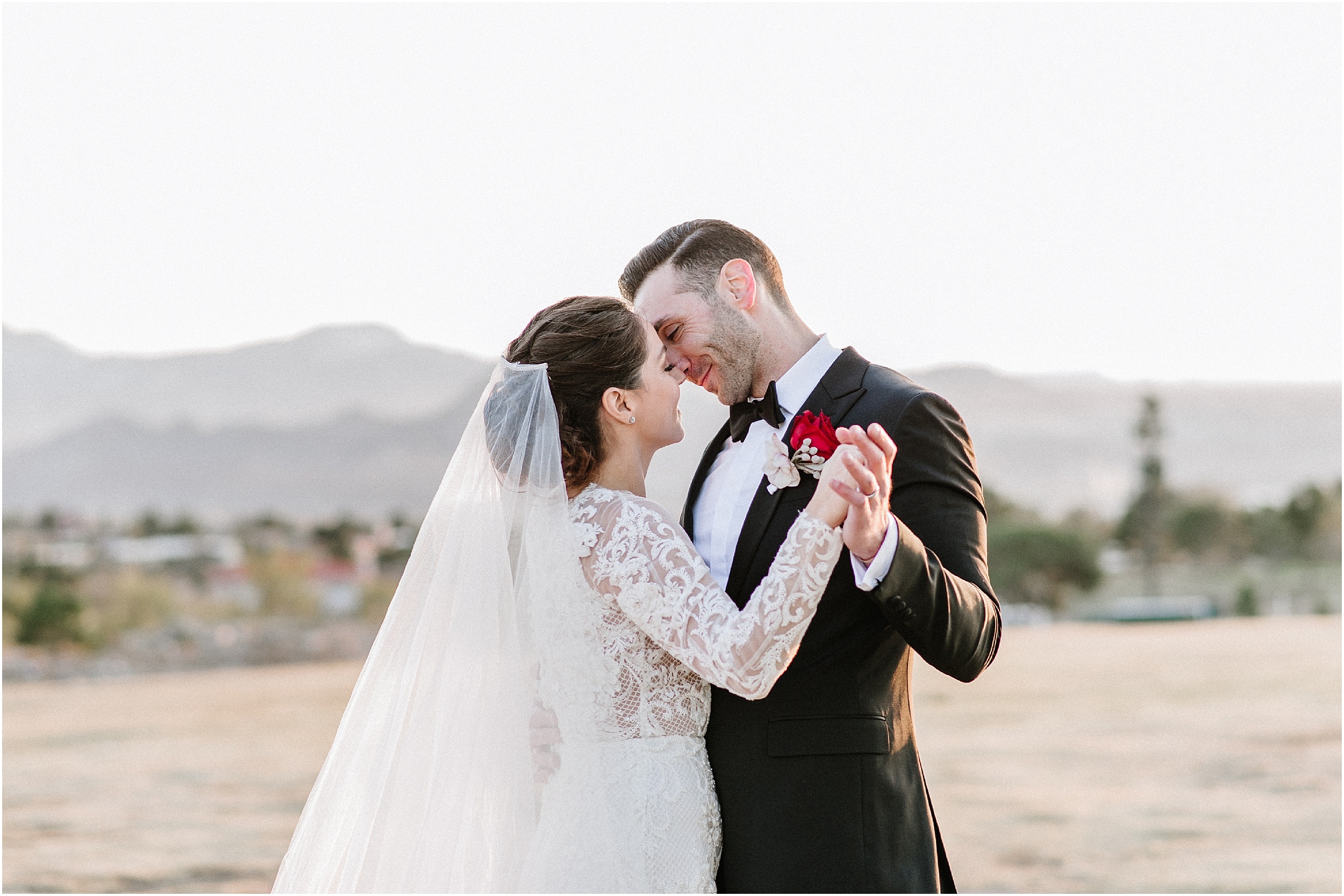 bride and groom dancing in front of mountains in el paso