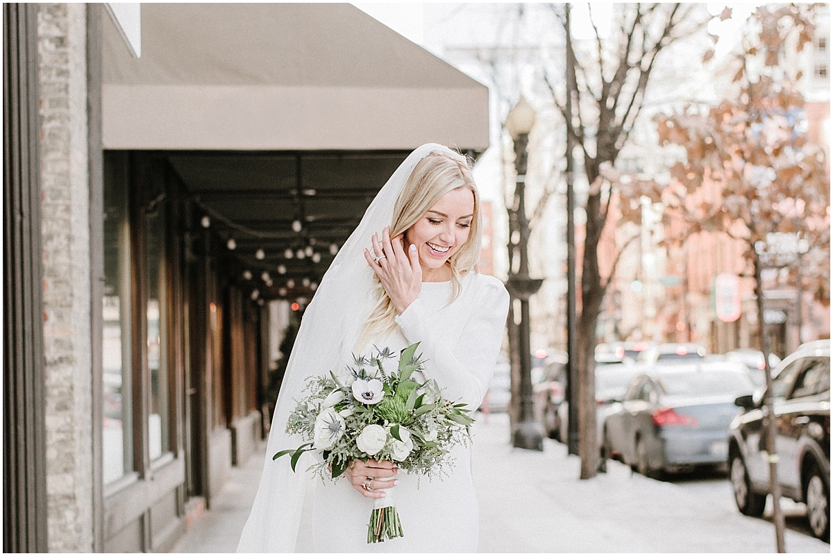 bride wearing long sleeve dress walking in downtown chicago