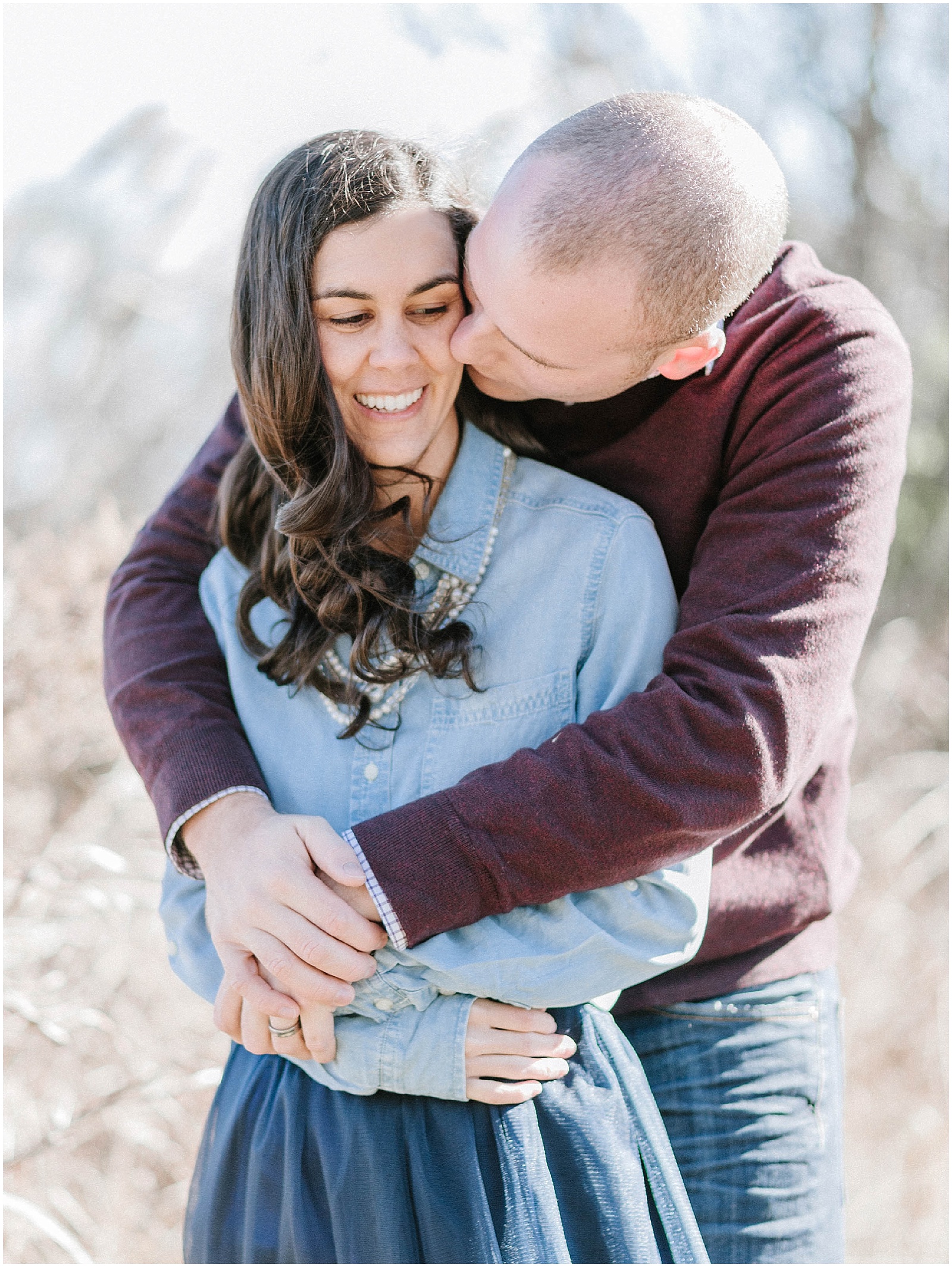 couple hugging during winter engagement photos