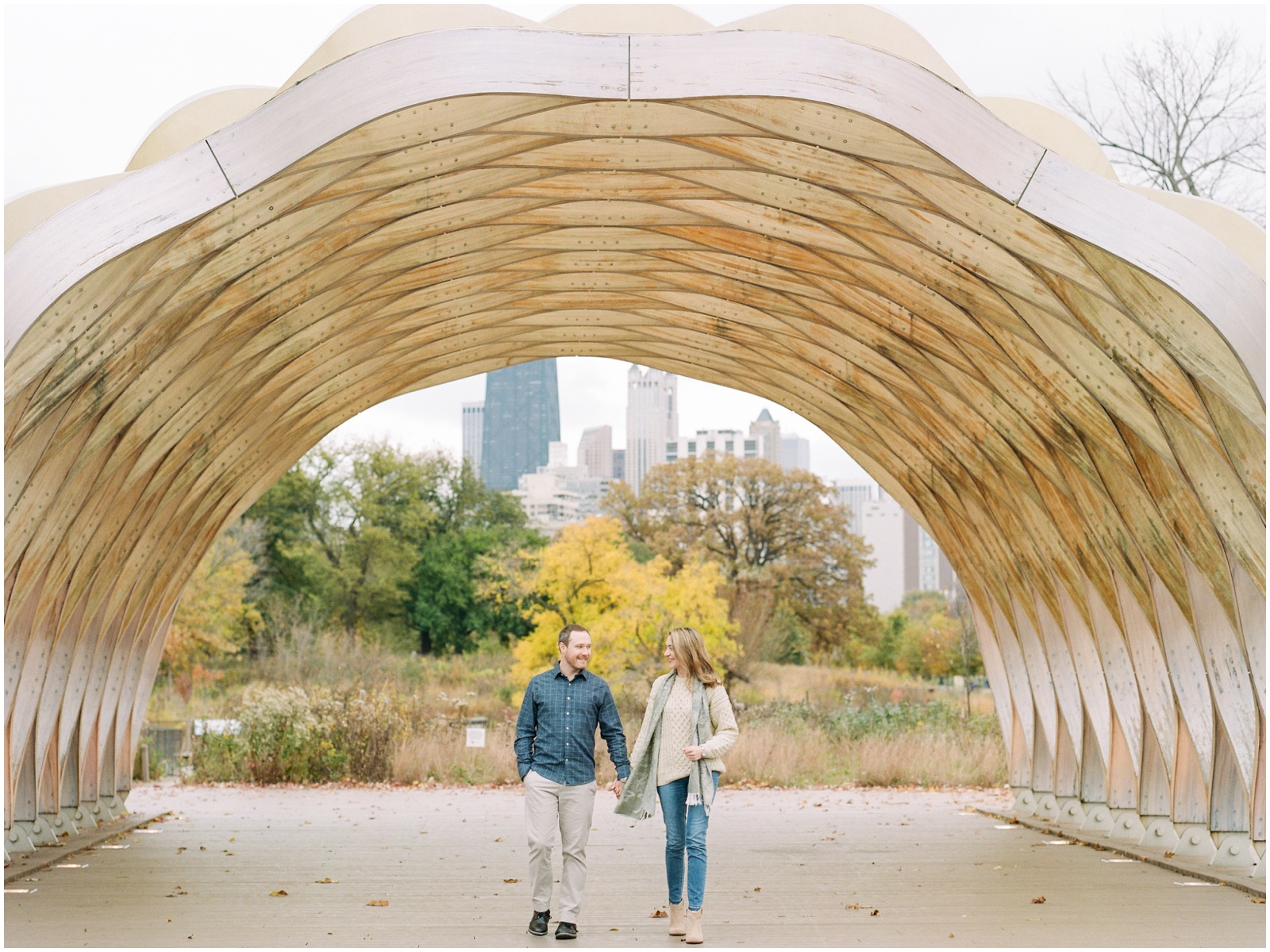 couple walking under an arch
