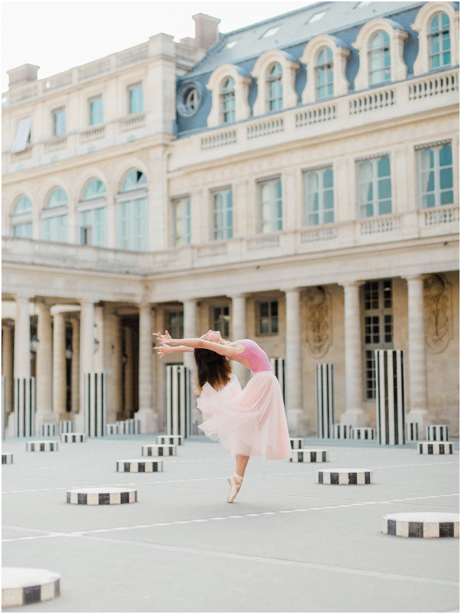 ballerina wearing pink tutu in paris at palais royal