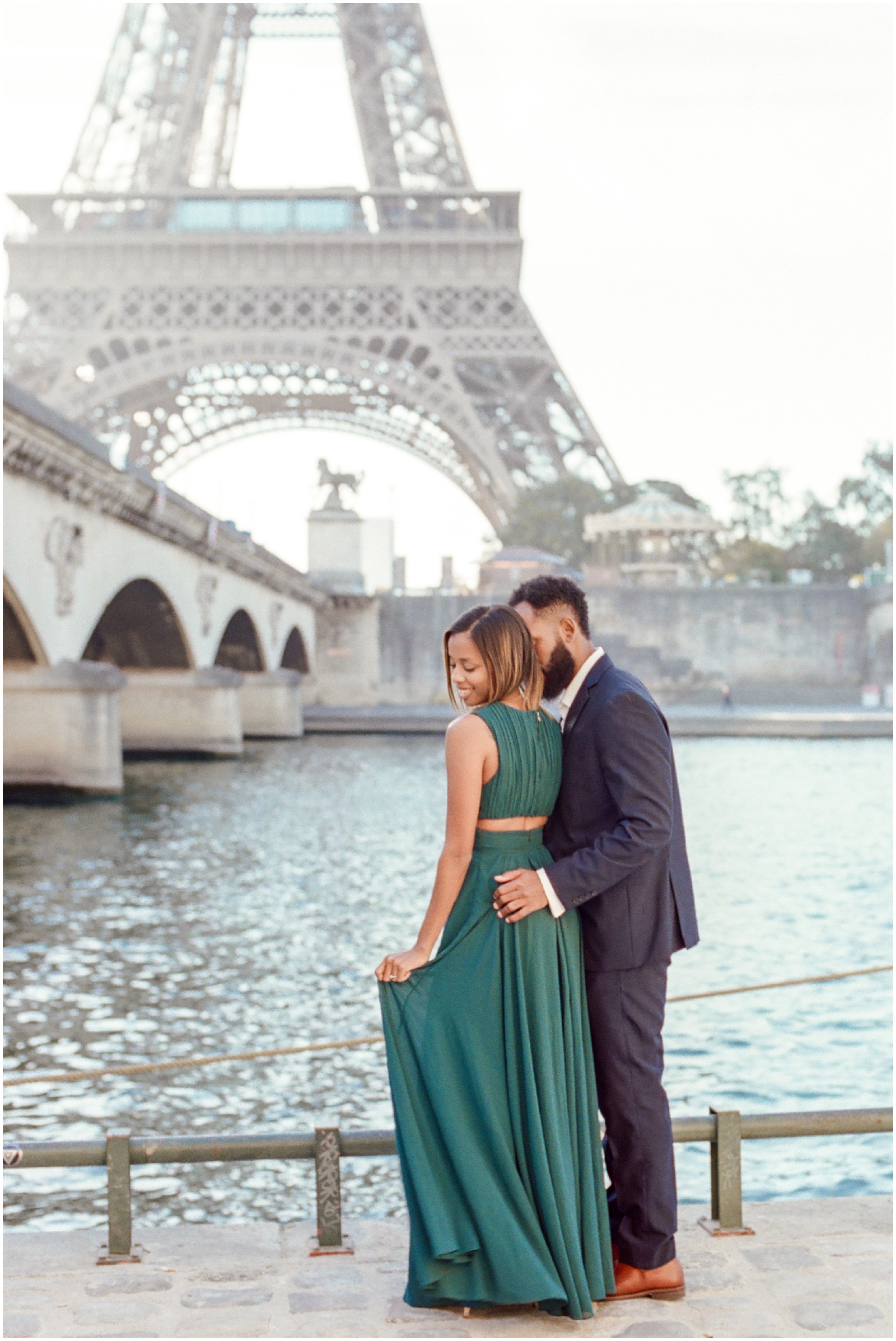 destination photographer couple standing in front of eiffel tower