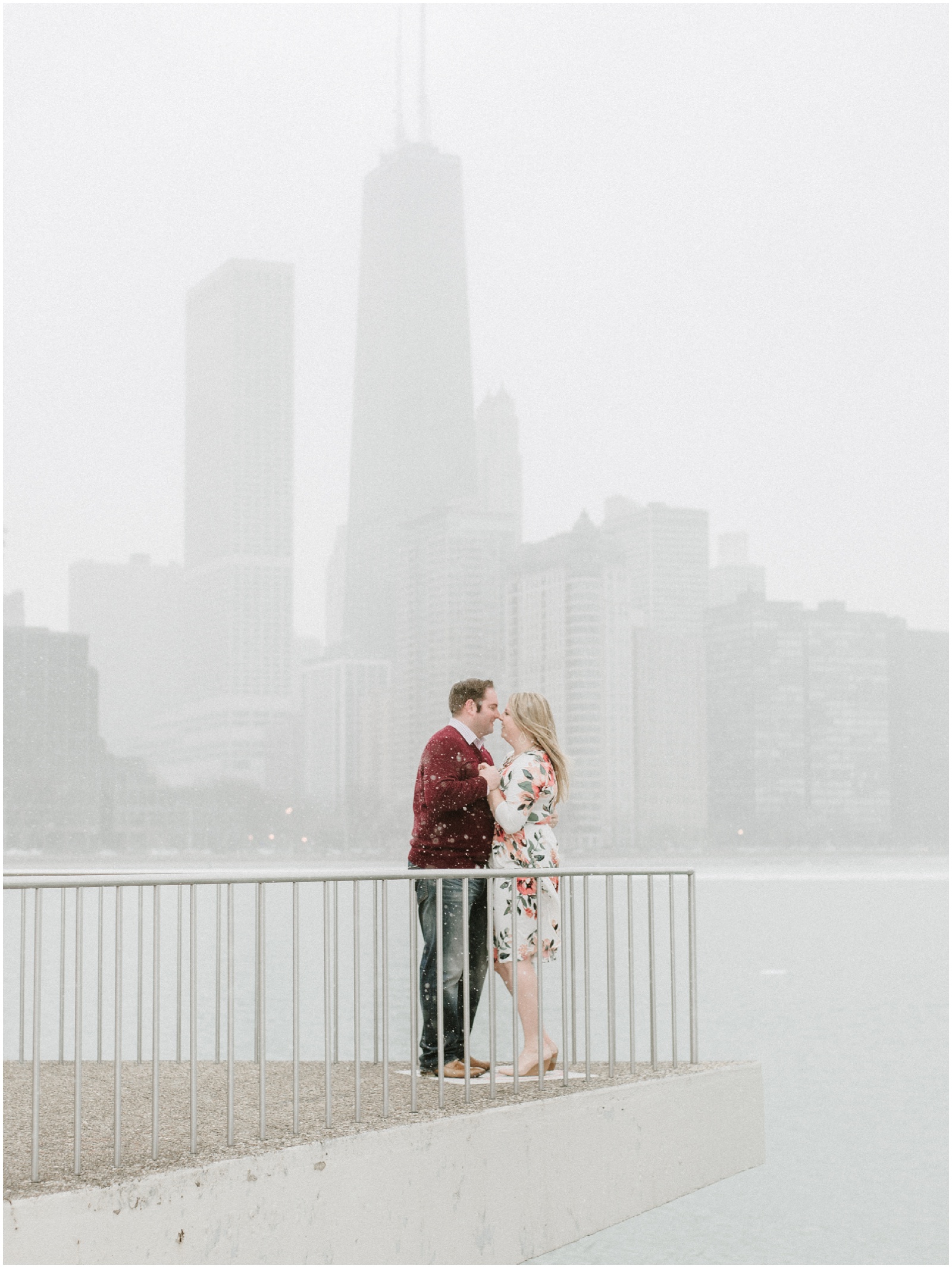 couple dancing on platform overlooking downtown chicago during engagement session