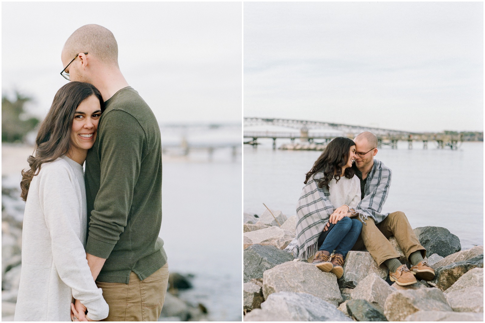 couple sitting on rocks in front of river and bridge during engagement session
