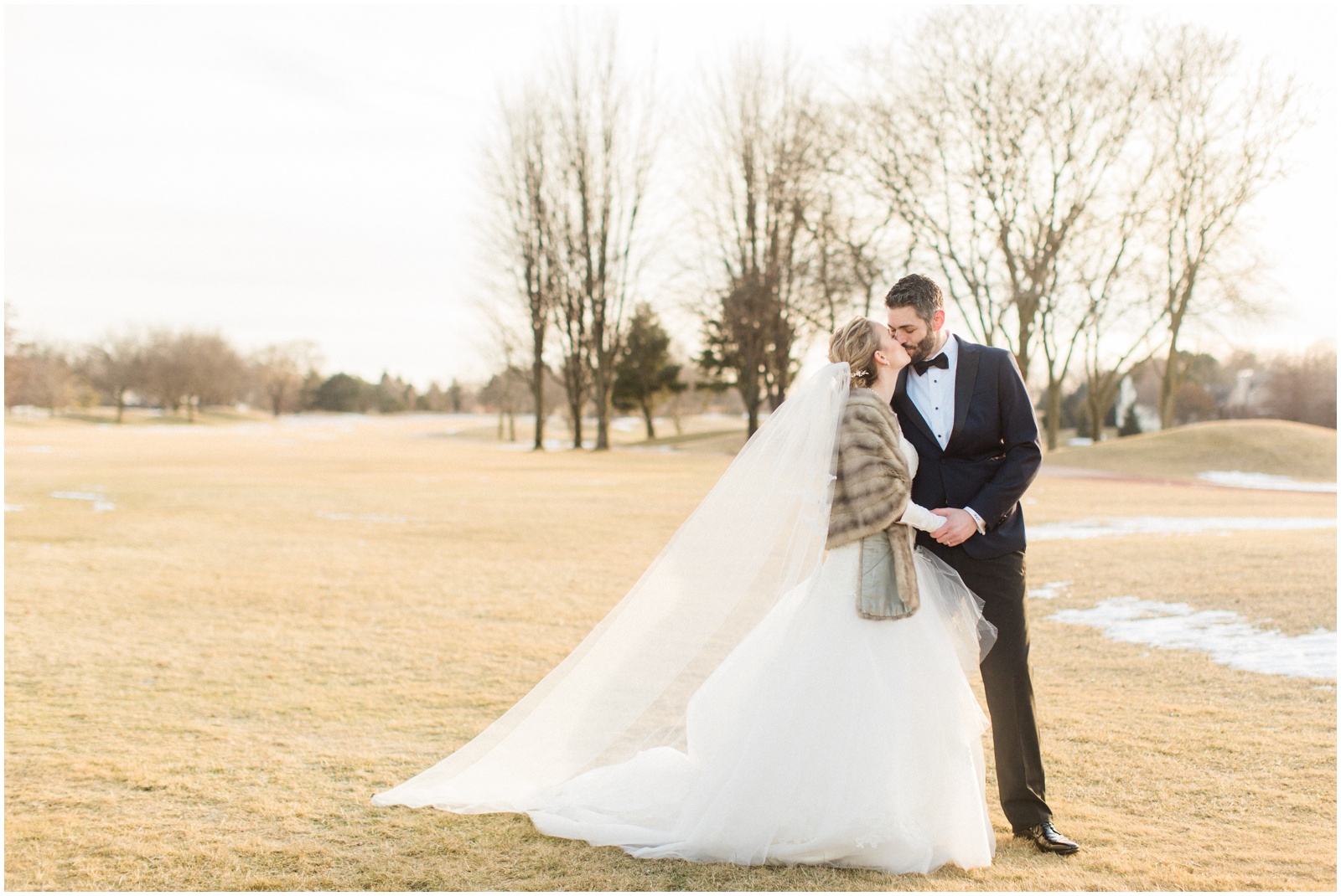 bride and groom on golf course in winter