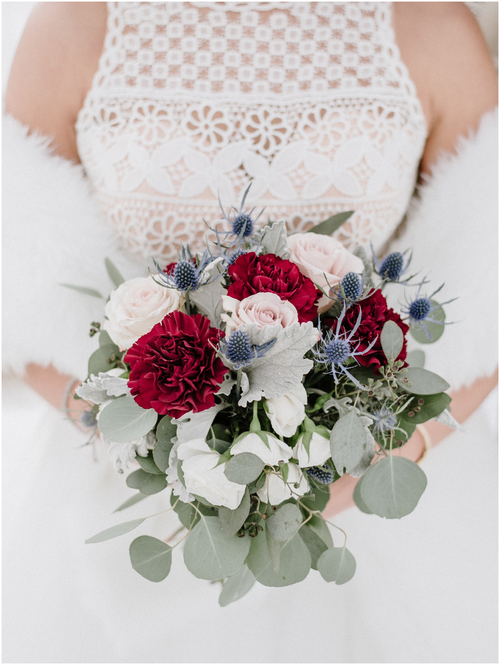 bride holding a blush and burgundy bouquet during winter wedding