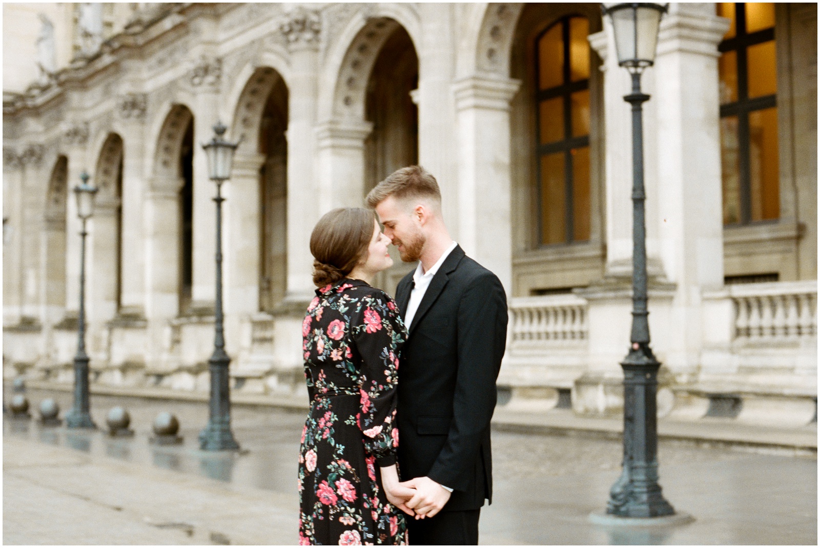 engaged couple outside of Louvre in Paris