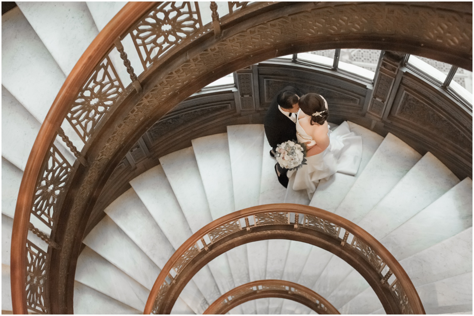 bride and groom on spiral staircase