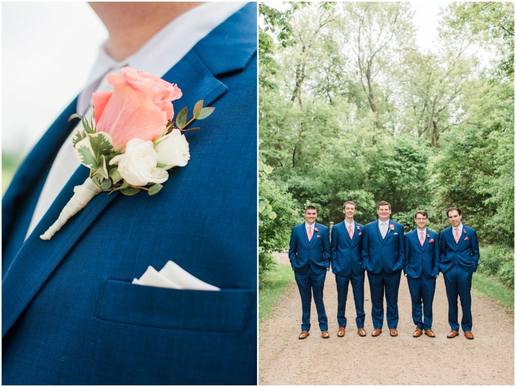 navy blue groomsmen suit with coral flowers