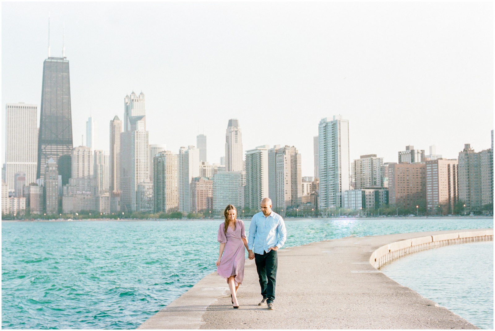 walking on pathway on Lake Michigan with Chicago skyline