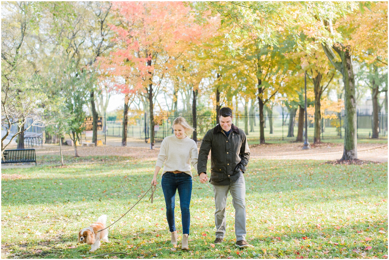 couple walking in a park with a dog