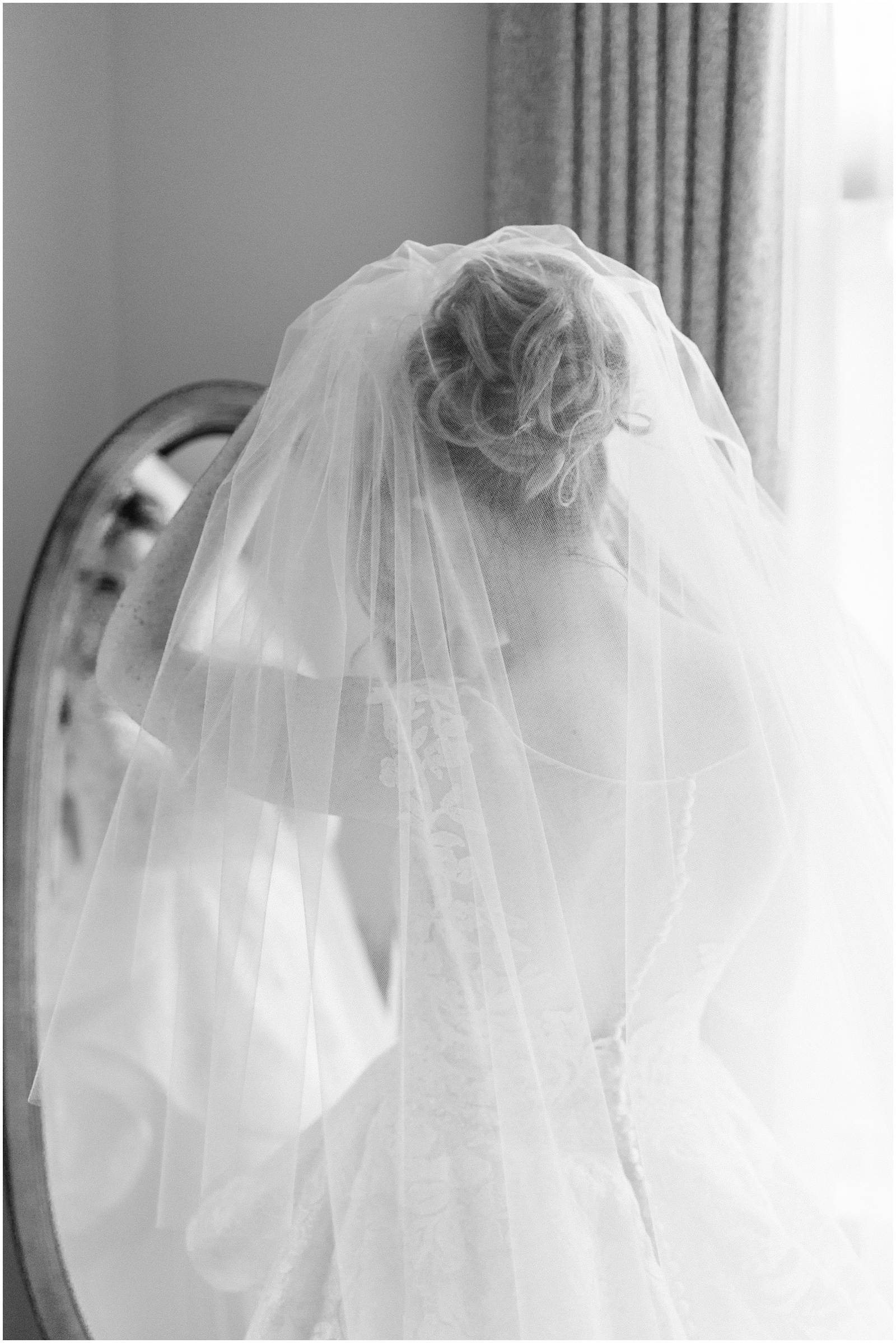 bride putting on veil