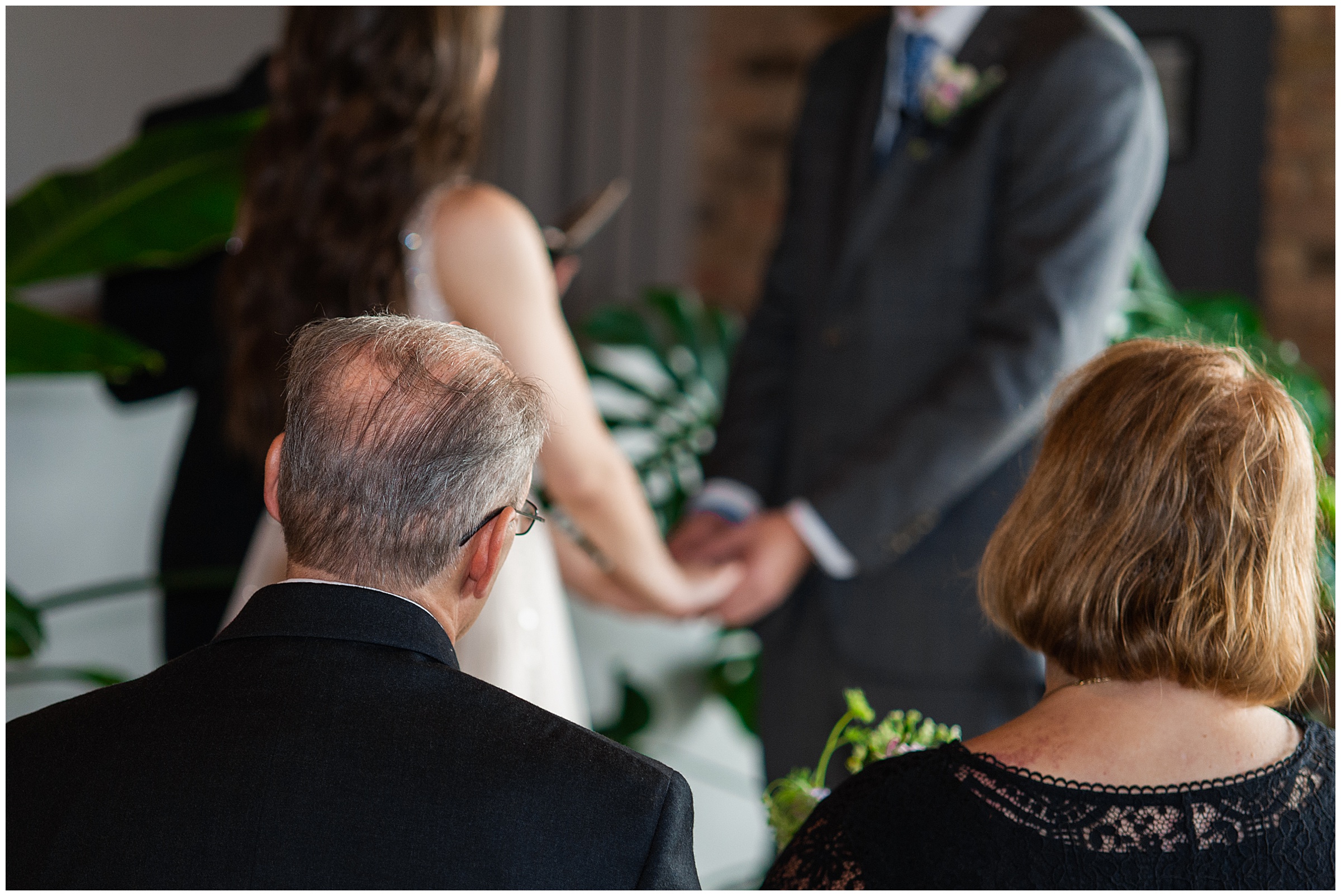 couple holding hands at altar